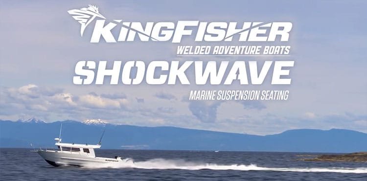 KingFisher Shockwave welded adventure boat with marine suspension seating navigating through water against a backdrop of mountains.