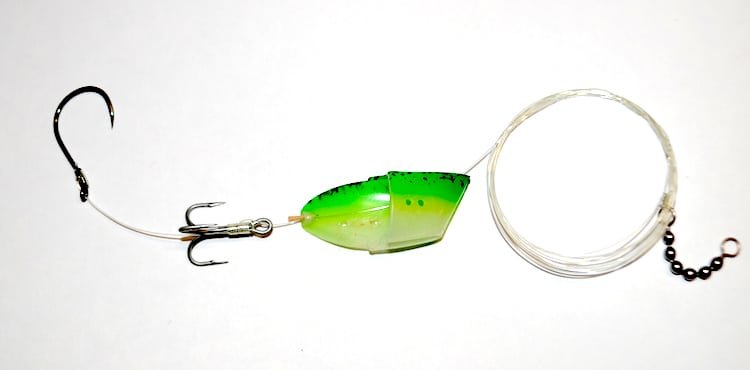 Traditional fishing leader with a green and yellow lure, treble hook, and clear fishing line attached.