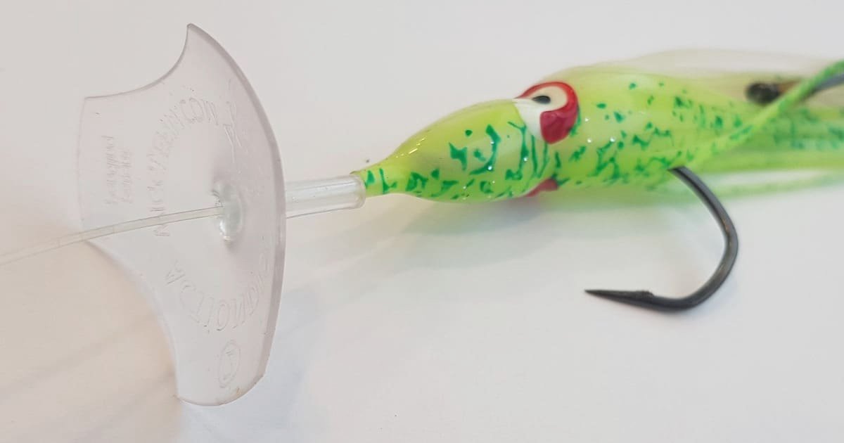 Green fishing lure with a transparent diving bill and a black hook, designed for attracting fish in freshwater or saltwater environments.
