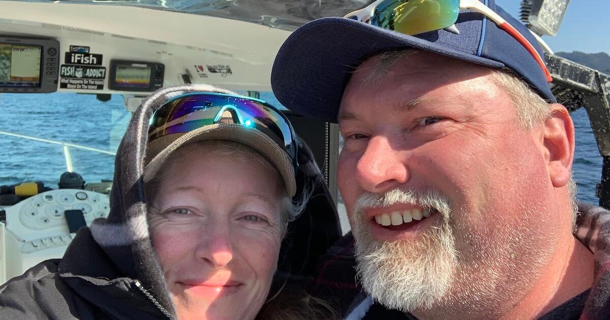 Two individuals smiling while on a boat, with fishing equipment and instruments visible in the background.