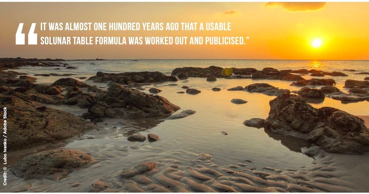 Scenic view of a rocky beach at sunset, with calm water reflecting the orange hues of the sky.