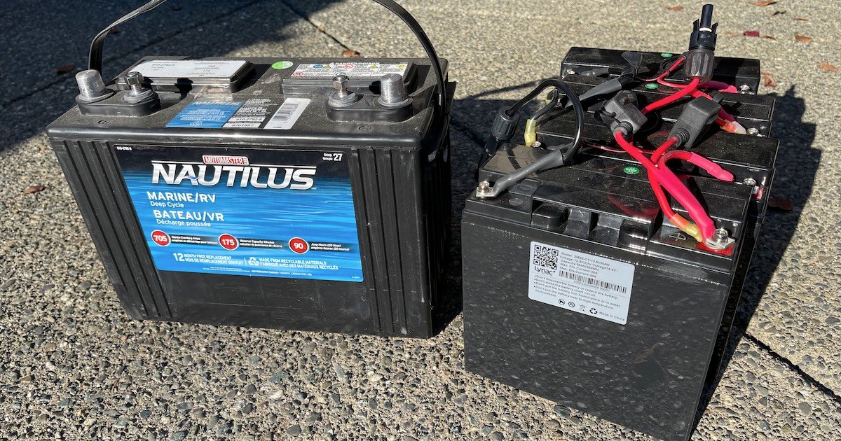 Two types of batteries side by side: a marine/RV lead-acid battery and a lithium battery with visible wiring.