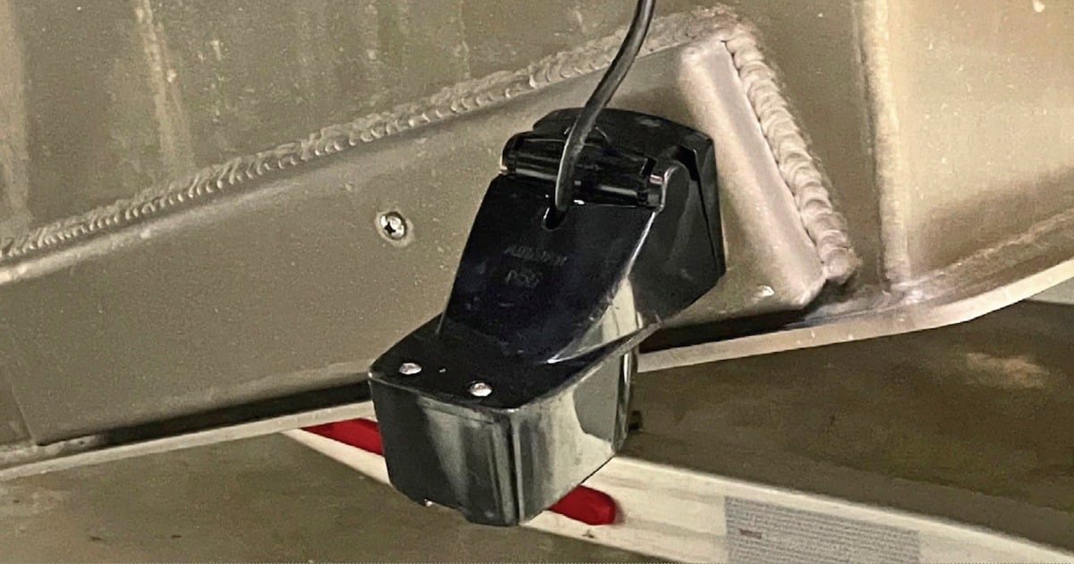 Transducer mounted on the hull of a boat, designed for sonar and fish finding applications in marine environments.