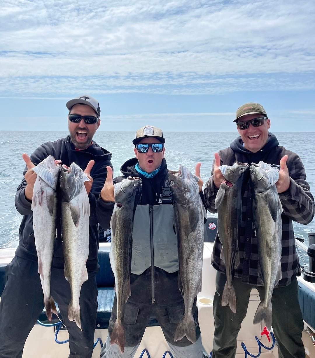 Professional BC fishing guides Rob Frawley and Lance Desilets landing a large Black Cod (Sablefish) off Tofino.