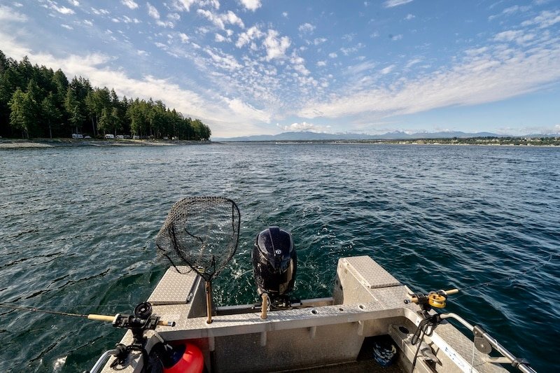Boat trolling two fishing lines on the ocean